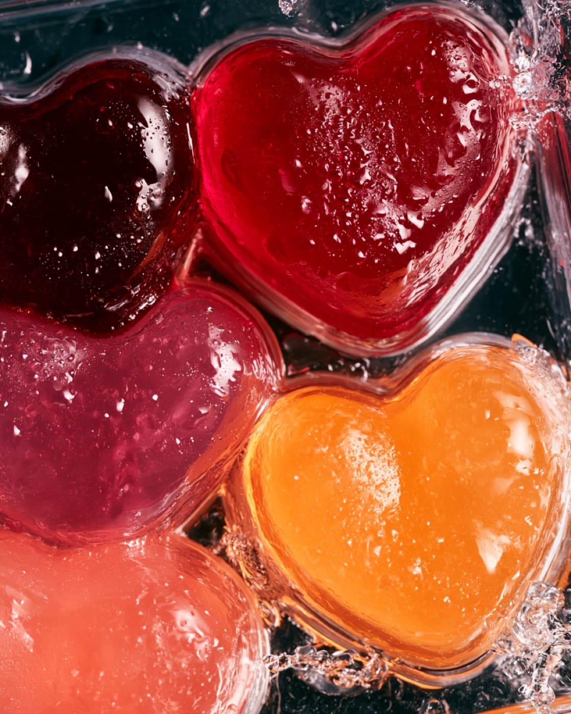 Macro view of fruit marmalade hearts under running water